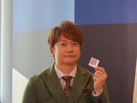 応援のチカラプロジェクトのシールを見せるスペシャルアンバサダー・香取慎吾