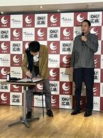 スラスラと筆を走らせたアンガールズの山根良顕（左）と見守る田中卓志