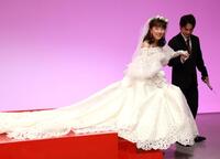 テレビ東京ドラマ「夫婦と１６歳～狂気の隣人～」記者会見で豆原一成（右）のエスコートを受けながら降壇するにウェディングドレス姿のかたせ梨乃（撮影・伊藤笙子）