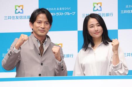 新ＣＭ発表会でポーズを決める岡田准一（左）と木村文乃（撮影・西岡正）