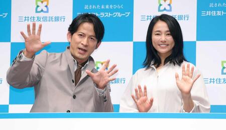 新ＣＭ発表会でポーズを決める岡田准一（左）と木村文乃（撮影・西岡正）