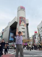 自身が起用された広告の前に立つ久保田かずのぶ