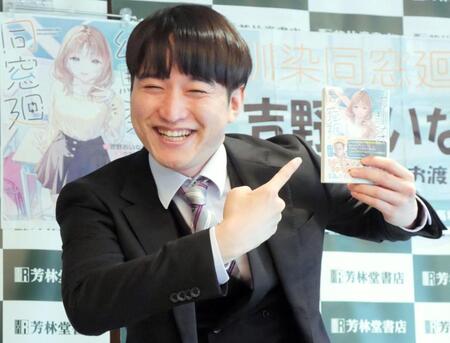 満面の笑みで著書をアピールする吉野おいなり君