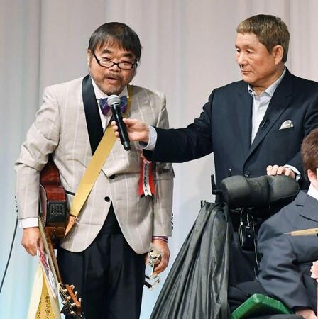 東京スポーツ映画大賞の授賞式でビートたけし（右）からマイクを向けられるグレート義太夫さん＝２０１９年２月