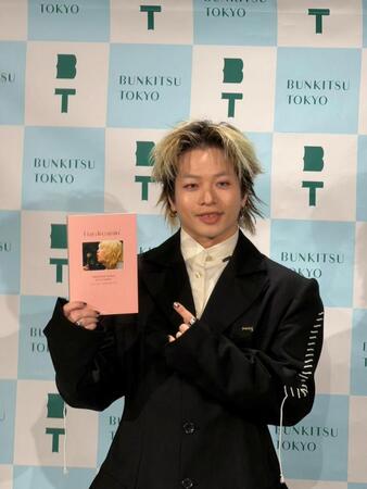 初の書籍を手に笑顔を浮かべる山本彰吾