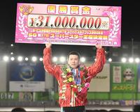 　スーパースターフェスタを制し賞金ボードを掲げる鈴木圭一郎（撮影・金田祐二）