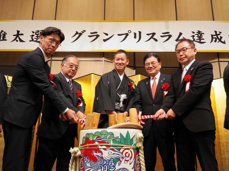 　鏡割りを行う脇本雄太（中央）