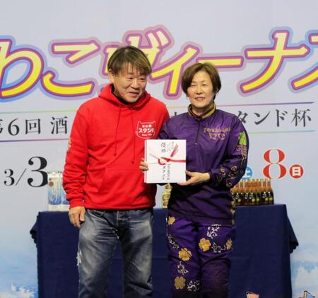 酒処境地新京極スタンド代表取締社長・杉山貞之氏（左）から目録を受け取った山川美由紀（右）