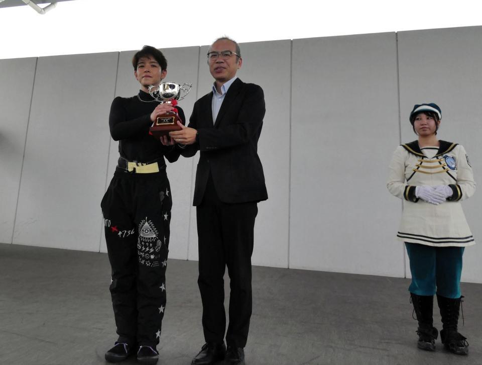 三原崇生デイリースポーツビジネス局局長から優勝カップを授与される高倉和士（左）