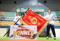 優勝旗を披露する大峯豊（右は白井英治）