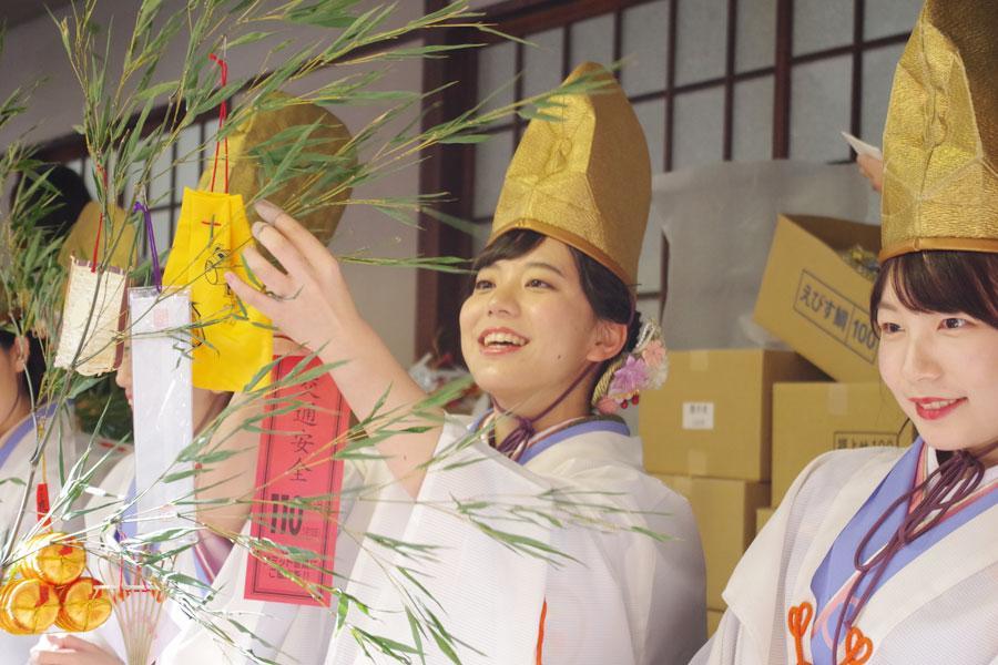 次々と差し出される福笹に縁起物をつけていく福娘（９日・今宮戎神社）