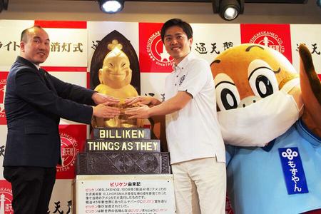 　幸運の神様ビリケンに「エアータッチ」する通天閣観光の高井社長と吉村洋文大阪府知事ともずやん（６月３０日・通天閣）