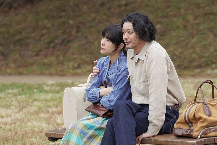 　京都・賀茂川の河川敷にて並んで座るるい（深津絵里）と錠一郎（オダギリジョー）（Ｃ）ＮＨＫ
