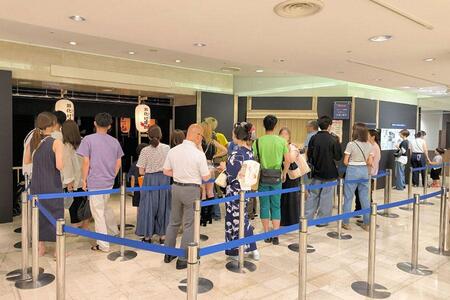 　「甦る!!令和の比叡山お化け屋敷」に並ぶ来場者。会場前の大きな看板で記念撮影する姿も多いそう（京都市下京区・大丸京都店）