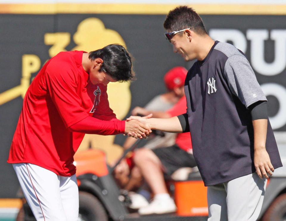 試合前、田中（右）と握手を交わす大谷（共同）　