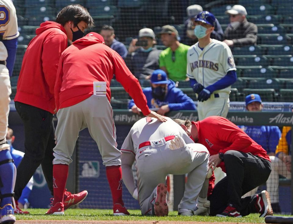 マリナーズ戦の１回、死球を受けうずくまるエンゼルス・大谷（左から３人目）＝シアトル（共同）