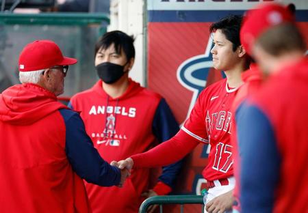 　レイズ戦の６回、遊ゴロに倒れベンチに戻り、マドン監督（左）と握手を交わすエンゼルス・大谷。このまま降板した＝アナハイム（共同）