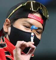 ＢＩＧＢＯＳＳのボブルヘッドをテレビカメラに見せる新庄剛志ビッグボス（左）＝２２年７月