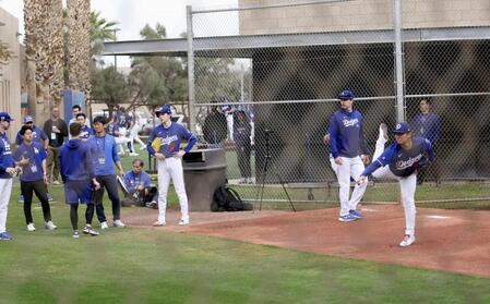 　ブルペンで投球練習する山本。右から３人目は佐々木