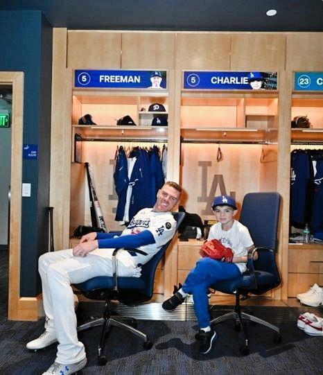 　ロッカーで笑みを浮かべるフリーマンと長男のチャーリー君（ジョン・スーフー／ドジャース提供）