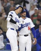 　１回、この回２度目の打席で右前適時打を放ち、一塁コーチ（右）とヘルメットを合わせる大谷（共同）