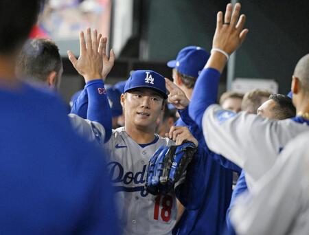 　レンジャーズ戦の７回まで無失点で終え、ハイタッチで迎えられるドジャース先発の山本。３勝目を挙げた（共同）