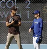 　パドレスのダルビッシュ（左）と話すドジャース・山本（共同）