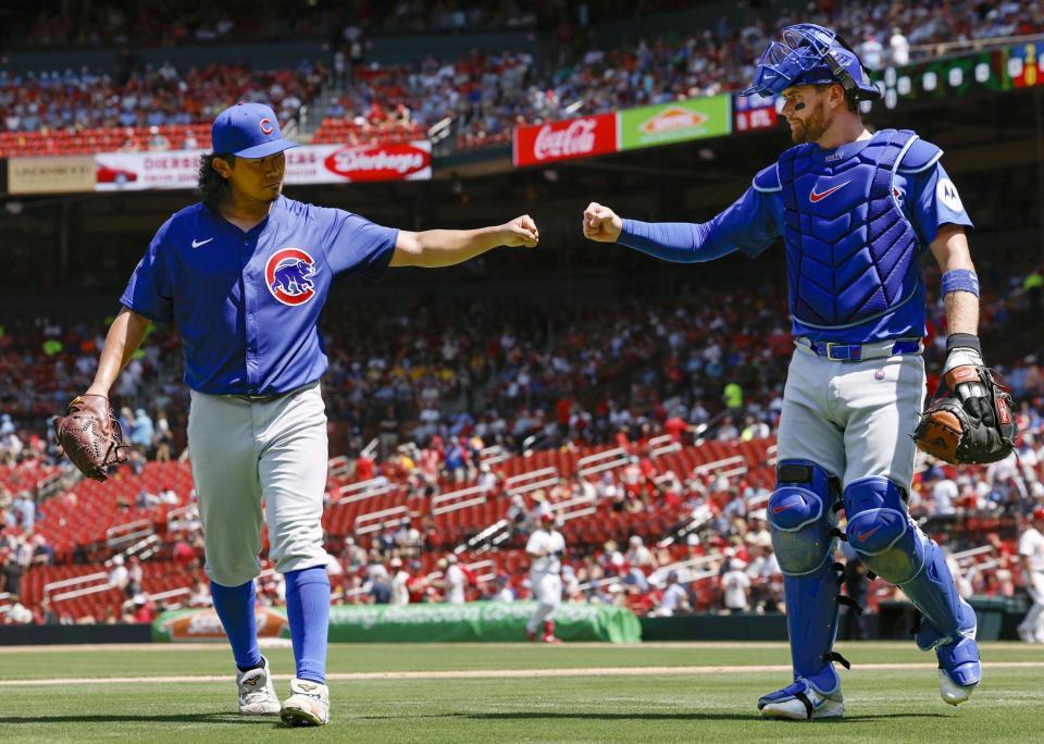 　先発して５回を投げ終え、捕手ケリーとタッチを交わす今永（共同）