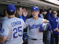 　ジャイアンツ戦の７回を投げ終え、ベンチでタッチを交わすドジャース・山本（共同）