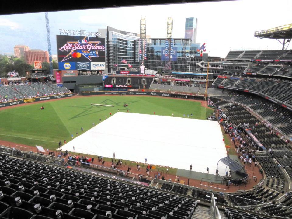 　突然の雨でシートが敷かれたフィールド（撮影・小林信行）