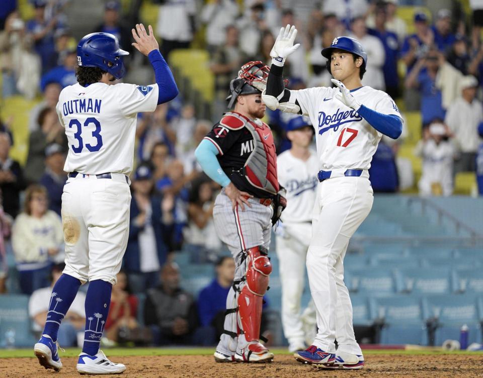 　９回、２ランを放ちアウトマンとタッチを交わす大谷（共同）