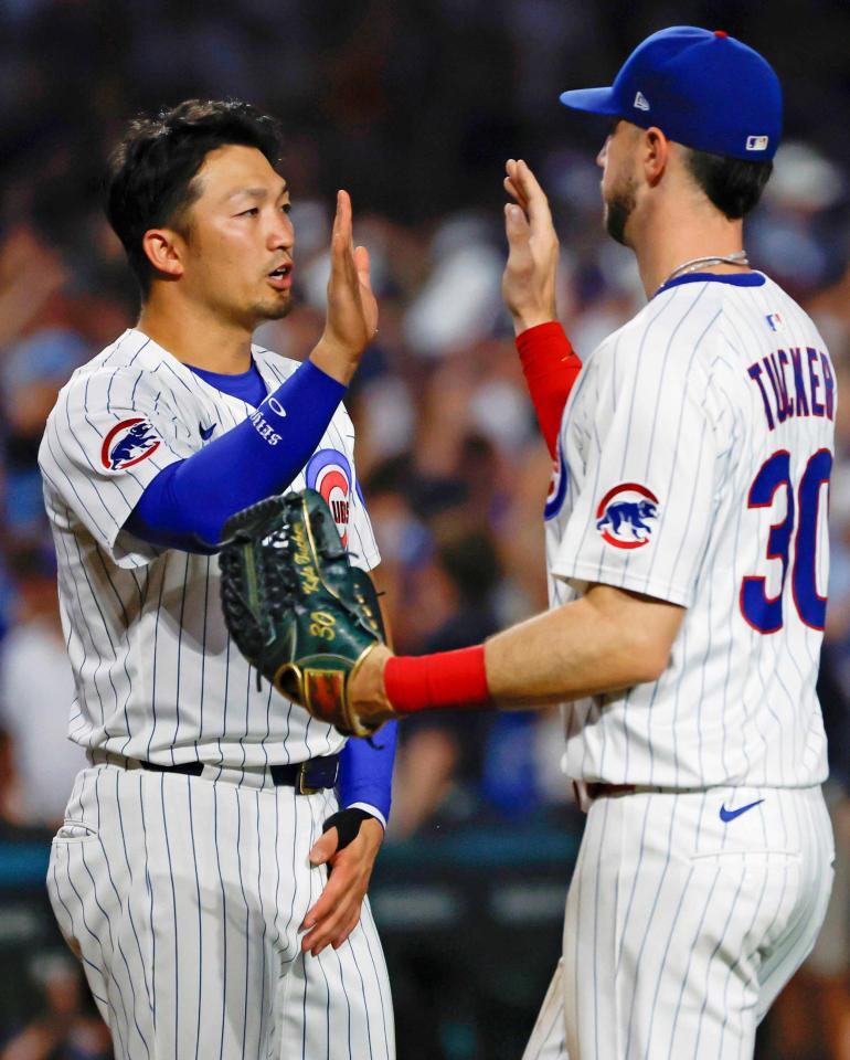 　ロイヤルズに勝利し、タッカー（右）とタッチを交わす鈴木（共同）