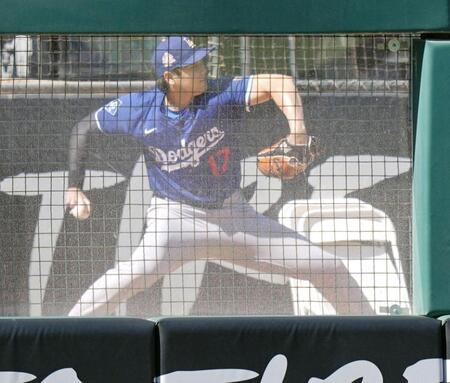 　ブルペンで投球する大谷（共同）