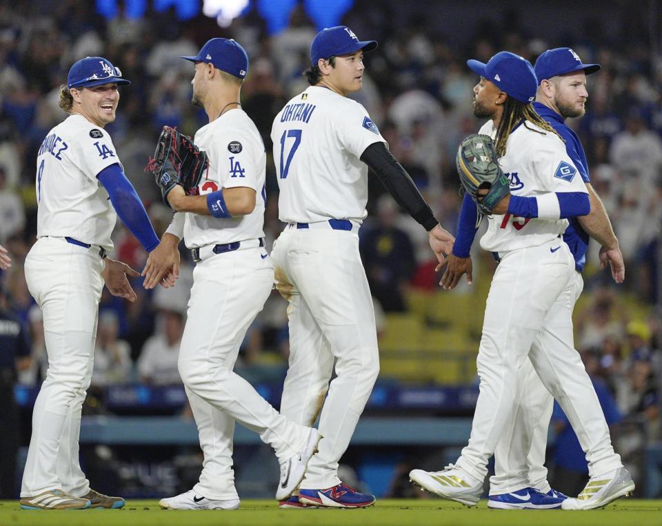 　レッズに勝利し、チームメートとタッチを交わす大谷（中央）＝共同