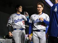 　オリオールズ戦の５回、空振り三振に倒れベンチに戻ったドジャース・大谷。右は山本（共同）