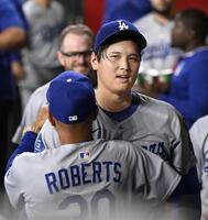 　ダイヤモンドバックス戦に先発し、６回を無失点で投げ終え、ロバーツ監督（手前）に迎えられる大谷（共同）