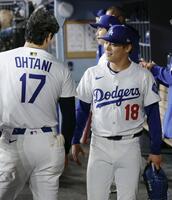 　レッズ戦の７回途中、２失点で降板しベンチで大谷（17）と言葉を交わす山本（共同）