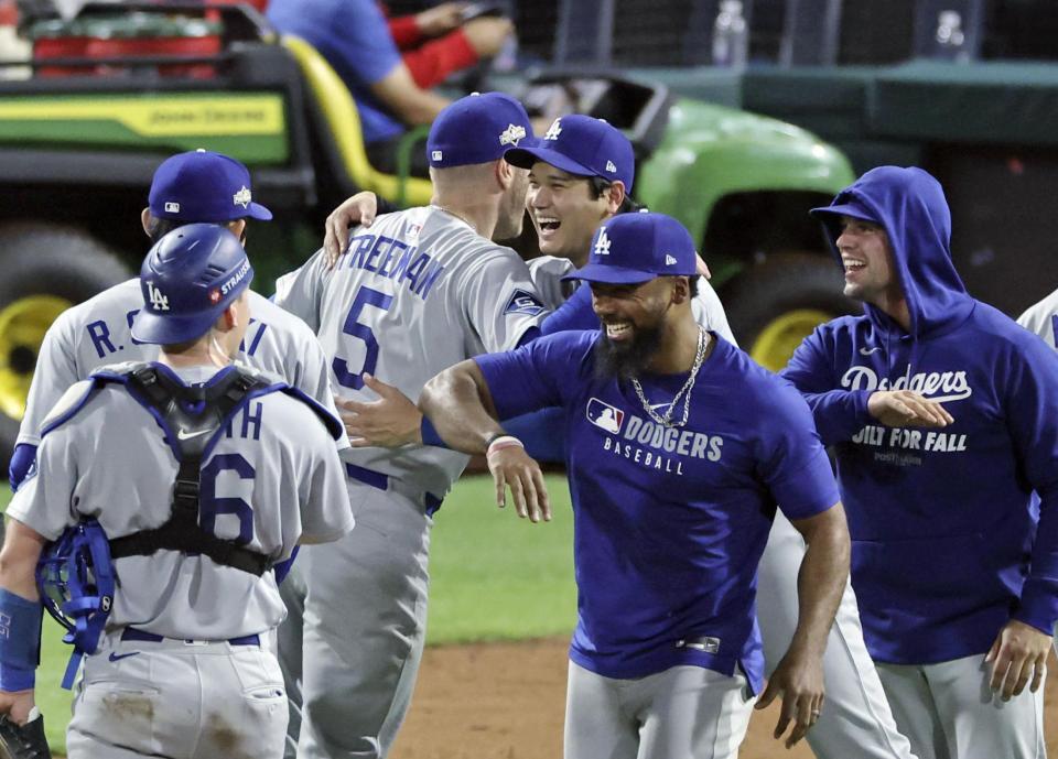 　フィリーズに勝利し、フリーマン（５）と抱き合う大谷（共同）