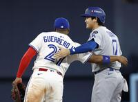 　ブルージェイズ戦の９回、四球で出塁し一塁手ゲレロと言葉を交わすドジャース・大谷（共同）