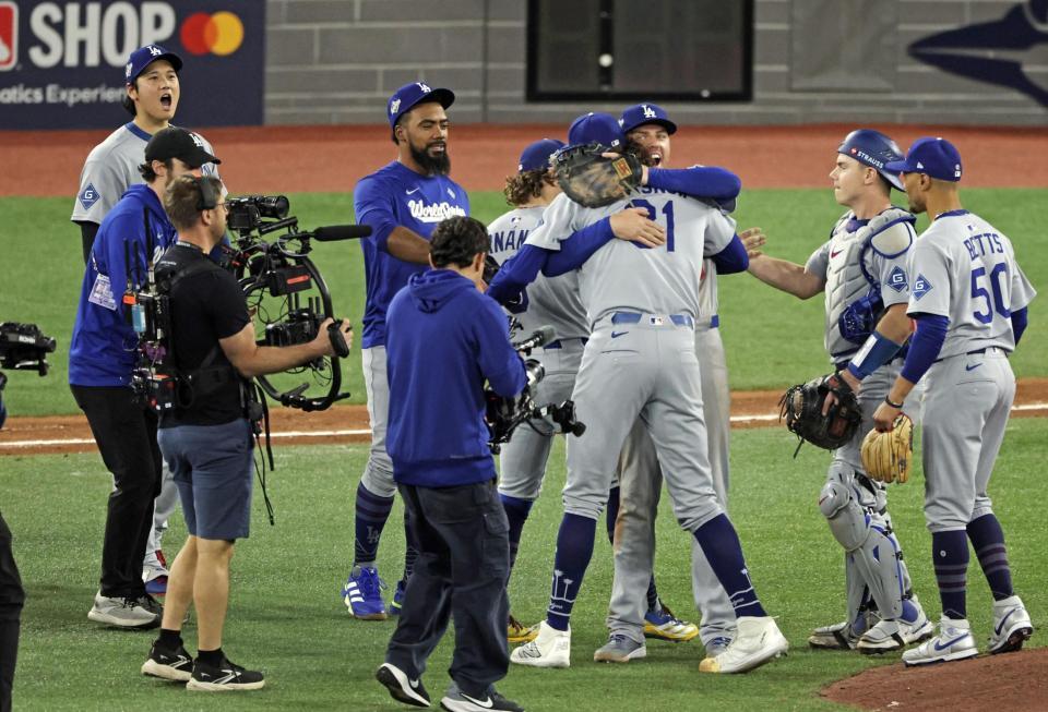 　米大リーグのワールドシリーズ第６戦でブルージェイズに勝利し、チームメートを迎えるドジャースの大谷翔平（左奥）＝31日、トロント（共同）