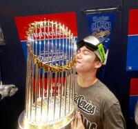 　シャンパンファイトでトロフィーと記念撮影する山本（代表撮影・共同）