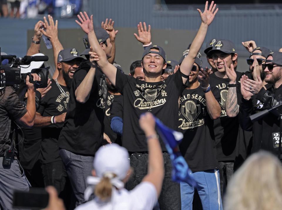 　ドジャースのワールドシリーズ優勝パレード後に開かれた報告会で歓声に応える、（前列左から）大谷翔平、ＷＳ最優秀選手に輝いた山本由伸、佐々木朗希の日本人３選（共同）