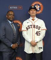 　米大リーグ、アストロズの入団記者会見で撮影に応じる今井達也投手。左はブラウンＧＭ（共同）