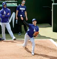 ブルペンで投球練習する大谷（共同）