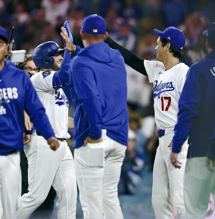 レンジャーズに勝利し、サヨナラ本塁打のマンシー（左）を迎えるドジャース・大谷（１７）＝１０日（共同）