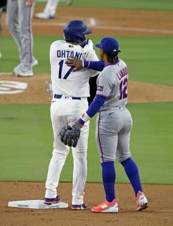 メッツ戦の１回、死球で出塁し後続の四球で二進し、遊撃手リンドア（右）と話す大谷＝ロサンゼルス（共同）