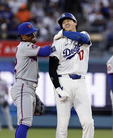 メッツ戦の１回、死球で出塁し後続の四球で二進し、遊撃手リンドア（左）と話す大谷＝ロサンゼルス（共同）