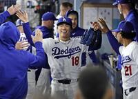 　メッツ戦の７回を投げ終え、ベンチで迎えられるドジャース・山本（共同）