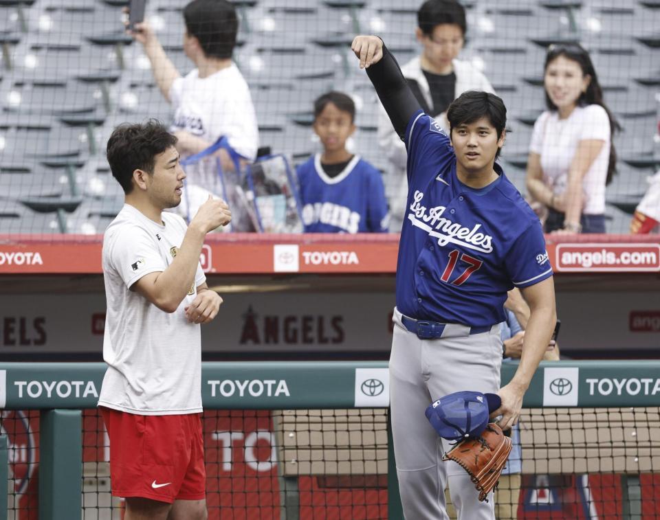 試合前に談笑する菊池（左）と大谷（共同）
