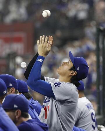 ９回、ベンチでボールを放る大谷（共同）